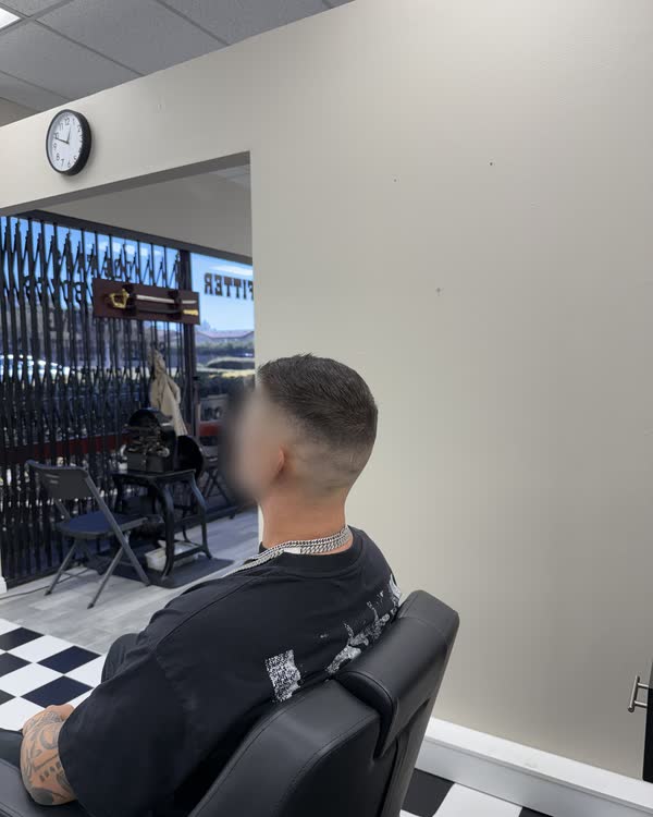 A finished skin fade, seen from behind the chair