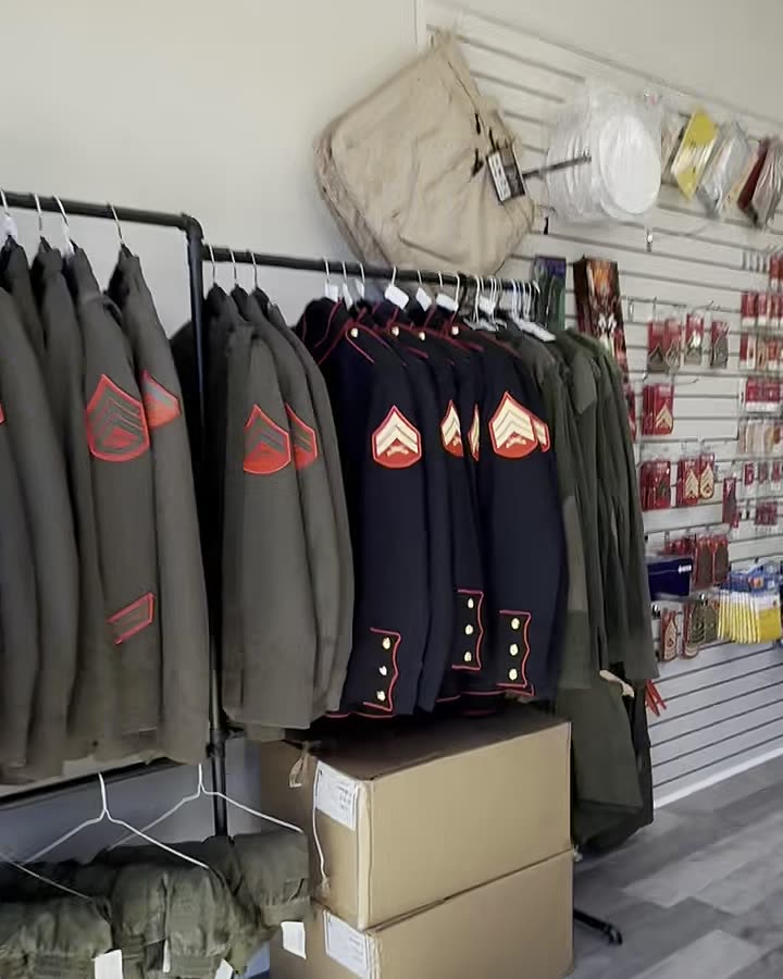 Inside Chesty's Military Outfitter: dress blues and chevrons hanging on the rack